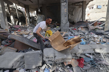 Un palestino revuelve escombros tras un bombardeo en Rafah. (Fuente: AFP)
