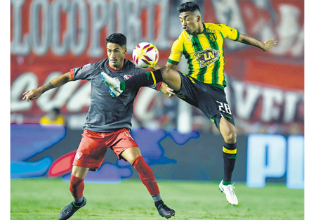 Ozuna y Pablo Hernández luchan por la pelota en una acción que se dio cerca del círculo central. (Fuente: Télam)