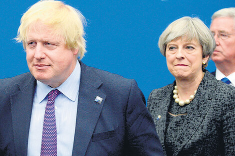 Entra Boris Johnson, sale Theresa May, parece decir la foto de ambos políticos.