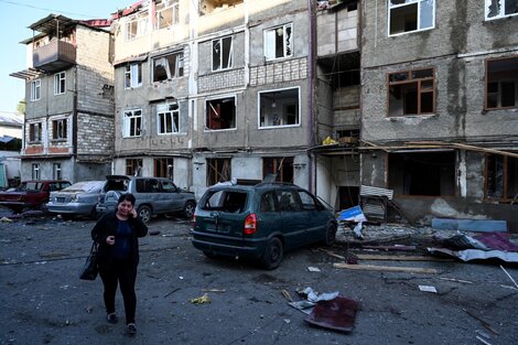 Un mujer llora al pasar frente a un edificio bombardeado en Stepanakert, Nagorno Karabaj