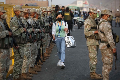 Militares y policías controlan una parada de transporte público este martes en las calles de Lima. 