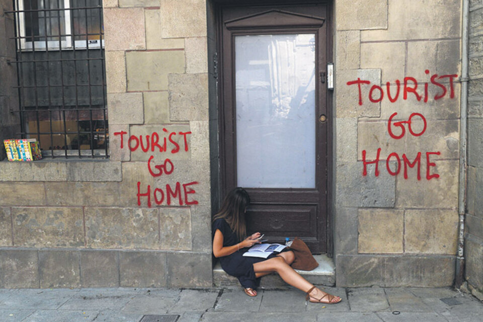 Pintada independentista en Barcelona en contra de los turistas.