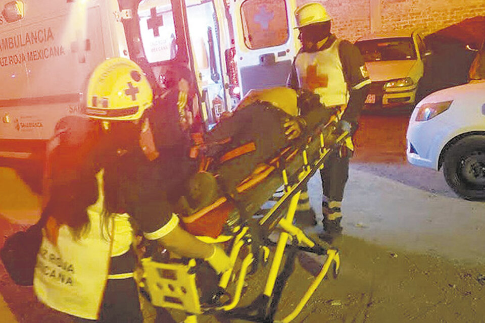 Paramédicos retiran a un herido en el ataque al bar de Guanajuato.