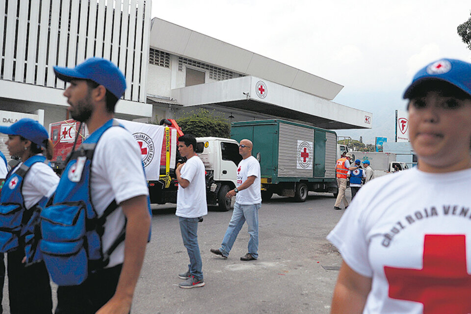 Vehículos de la Cruz Roja llegan ayer a la sede del organismo en Caracas. (Fuente: EFE)
