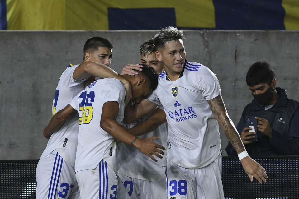 Todos abrazan a Medina, autor del primer gol xeneize (Fuente: Télam)