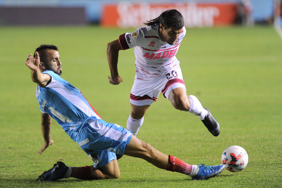 Malcorra intenta pasar ante Chimino; hubo igualdad entre Lanús y Arsenal (Fuente: Télam)