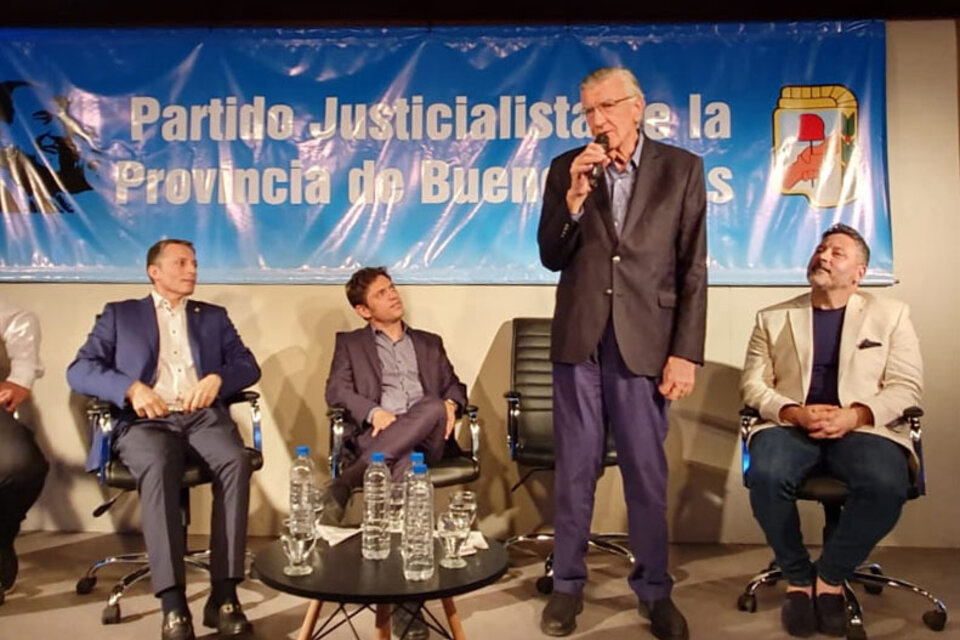Sentado en la foto a la derecha de Gioja, Menéndez escucha el discurso de Gioja.