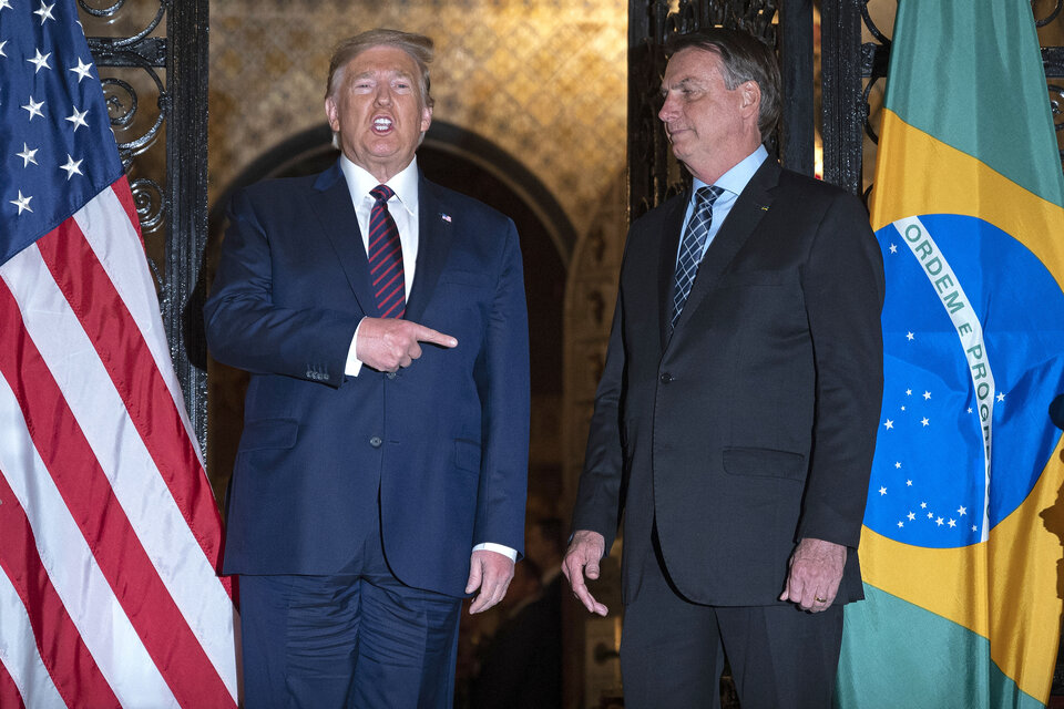 Trump señala a Bolsonaro durante una cena la casa del estadounidense en Palm Beach. (Fuente: AFP)
