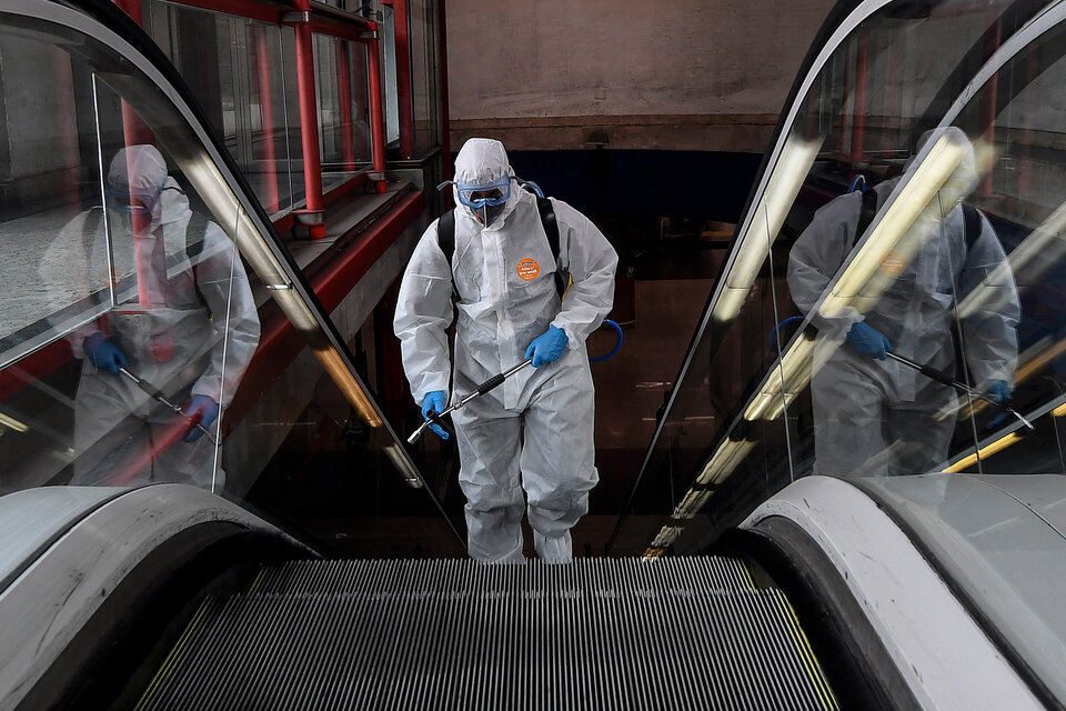 Un miembro del ejército español desinfecta en una estación de subte en Madrid. (Fuente: AFP)