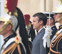 Macron rodeado de guardias ceremoniales durante un acto en el Elíseo.