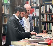 Gabriel Boric elige títulos en una librería de Palermo.