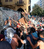 Manifestantes cargan contra una valla frente al Parlamento de Beirut. (Fuente: EFE)